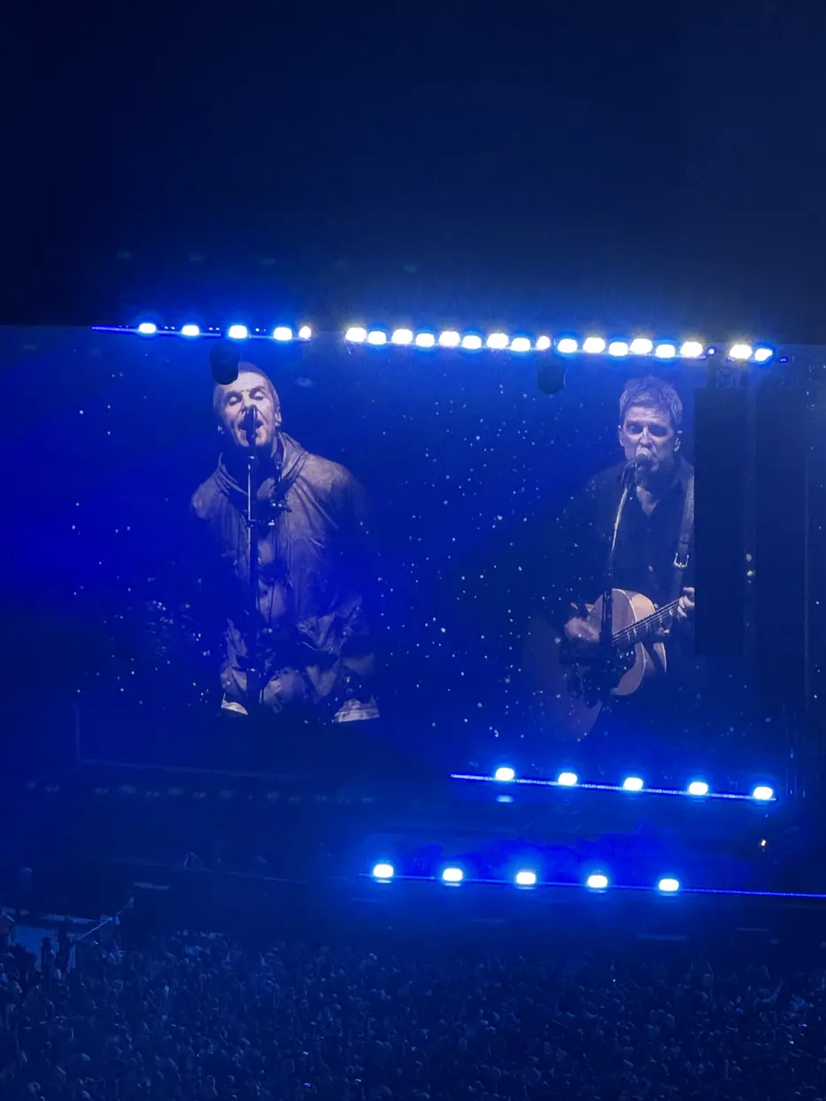 Liam and Noel Gallagher on the big screens at the Oasis concert in Cardiff